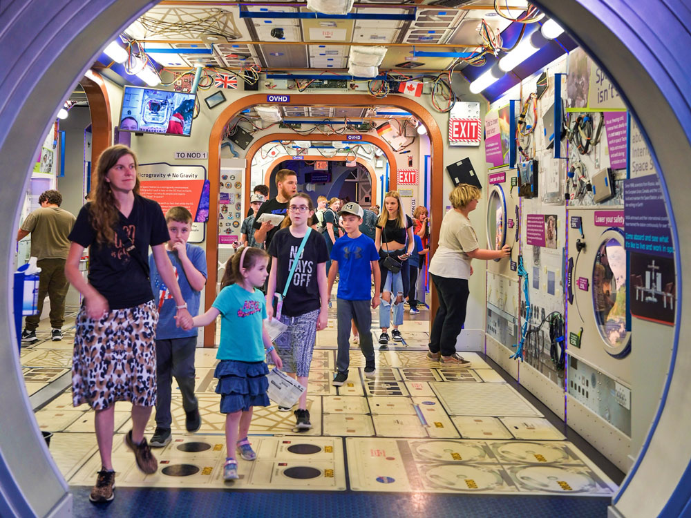 Families exploring the International Space Station in Beyond Spaceship Earth.